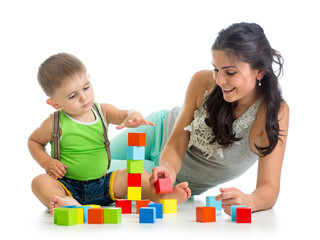 little boy and mother playing together with construction set toy