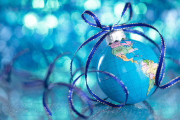 Christmas Globe in de-focused blue lights background.