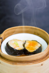 Shrimp and seaweed dumplings in a bamboo steamer