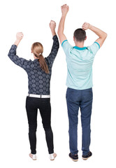 Obraz premium Back view of joyful couple celebrating victory hands up.
