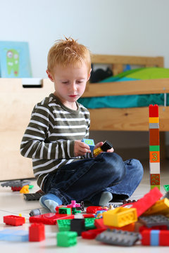 Boy playing with colored bricks