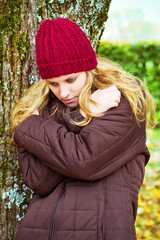 Young thoughtful woman in autumn