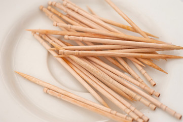 used toothpicks on a small white plate