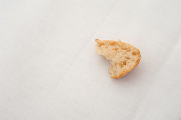 a piece of white bread on a table cloth