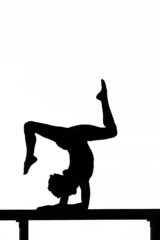 women contortionist practicing gymnastic yoga in silhouette