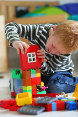 Boy playing with colored bricks