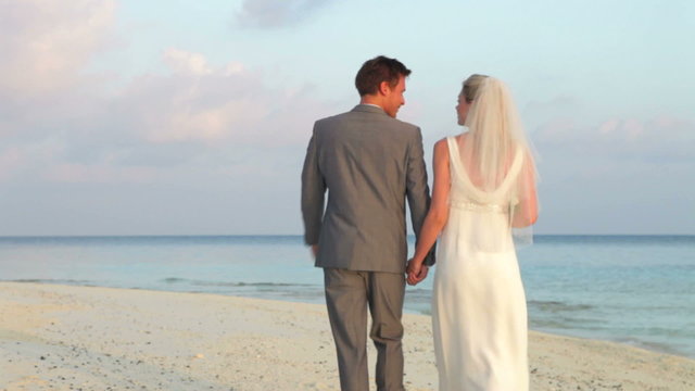 Rear View Of Couple At Beautiful Beach Wedding