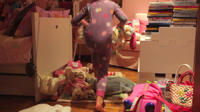 Time-Lapse Sequence Of Girl Moving Toys To Make Bed On Floor
