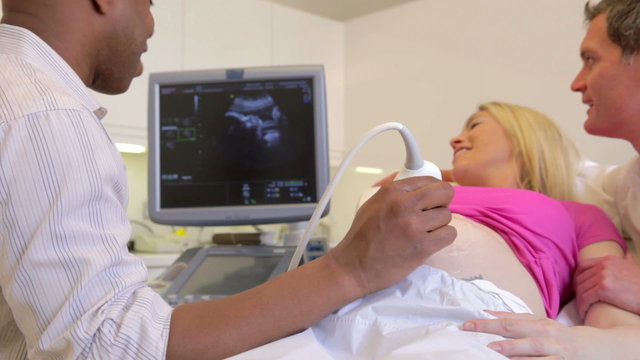 Pregnant Woman Having Ultrasound Scan With Partner