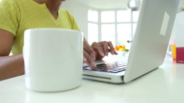 Close Up Of African American Woman Using Laptop At Home
