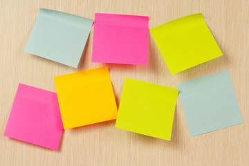 Colorful stickers on a wooden board from notice