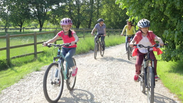 Hispanic Family On Cycle Ride In Countryside