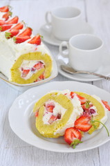 Swiss roll with cream and strawberries, selective focus