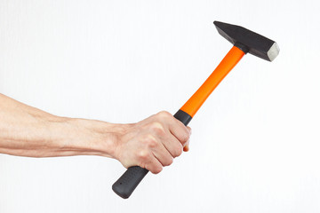 Hand of a carpenter with a hammer on a white background