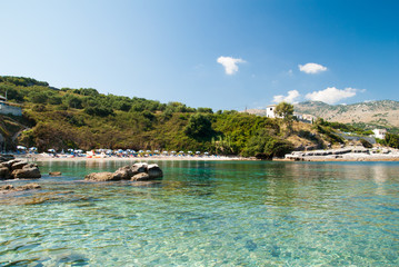 Fototapeta na wymiar Kassiopi Beach, Corfu Island, Greece. Sunbeds and umbrellas