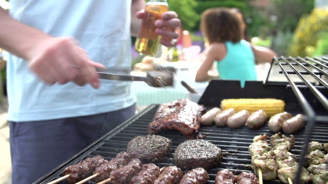 Close Up Of Of Man Cooking On Barbeque At Home