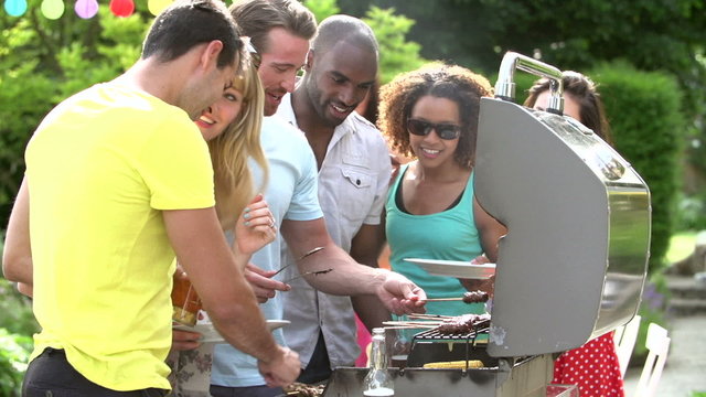 Group Of Friends Having Outdoor Barbeque At Home