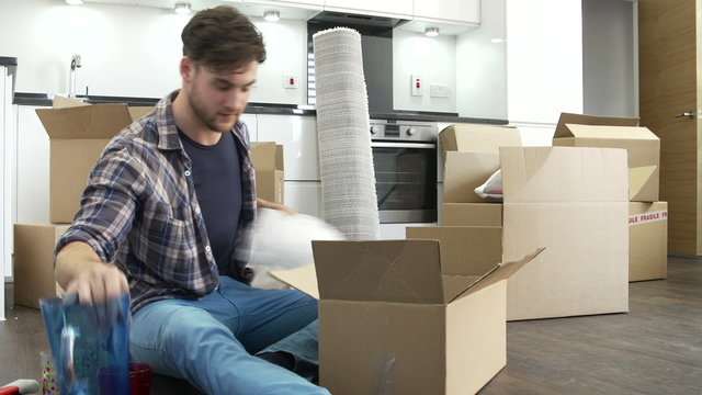 Man Sealing Boxes Ready For House Move