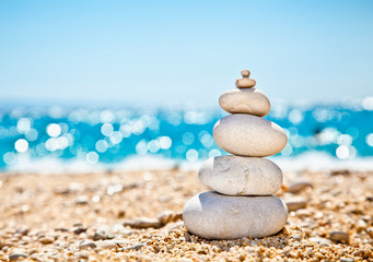 Stack of zen stones on beach.