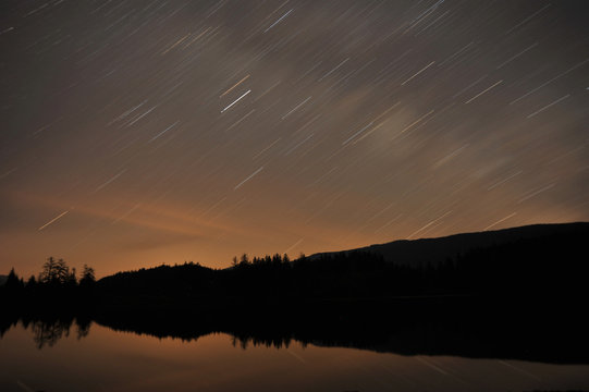 Star trails over lake