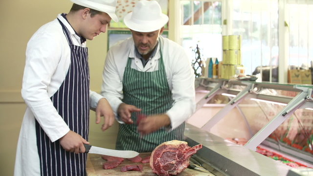 Butcher Teaching Apprentice How To Prepare Meat