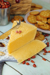 Cheese and crackers on wooden table close-up