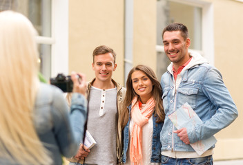 group of smiling friends taking photo outdoors