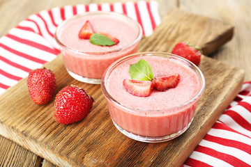 Delicious berry mousse in bowls on table close-up