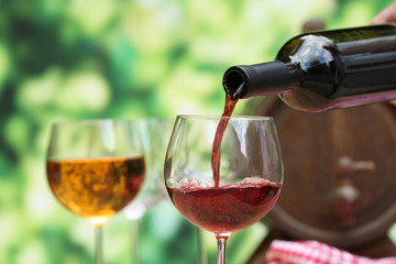 Red wine pouring into wine glass, close-up