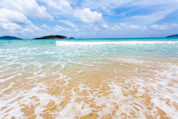 Closeup of sand and small wave
