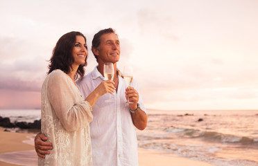 Romantic Couple Drinking Champagne on the Beach at Sunset