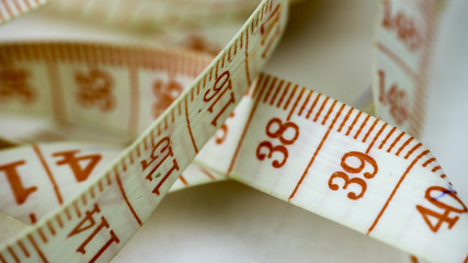 Red and white tailoring meter or tape measure. Close up.