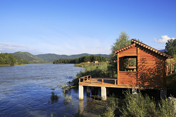 Wooden veranda on the mountain river Katun.