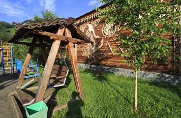 Wooden swing on the territory of the Tourist complex "Three bear