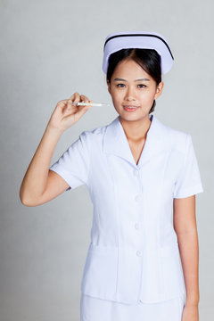 Young  Asian nurse show thermometer