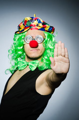 Funny clown against the dark background