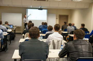 rear view of the people sitting in the class - 69793227