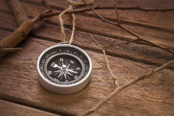 Compass on wooden background