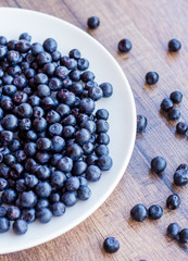 blueberries on a white plate, vertically