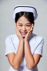 Portrait of  very happy young Asian nurse