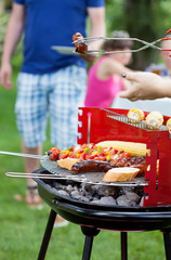 Friends during grilling in garden