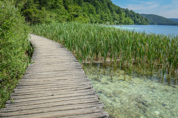 Fototapeta na wymiar Wooden Bridge over a Lake in Plitvice National Park