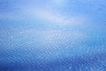 blue expanse of water in soft focus background and texture