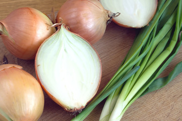 Ripe onion bulbs and chives closeup
