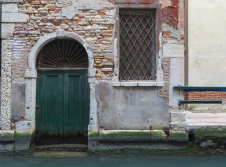 Detail of a door over a canal, Venice, Italy.