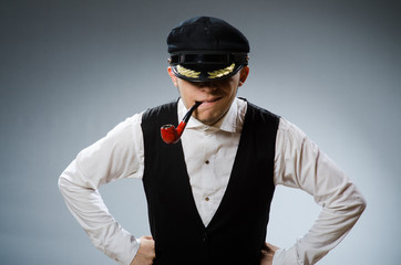 Captain smoking pipe with tobacco