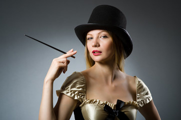 Woman magician with magic wand and hat