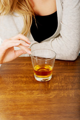 Yound woman in depression, drinking alcohol