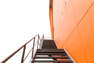 Metal fire escape or emergency exit on Orange Wall of Buliding