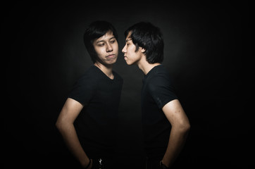 Nice male twins isolated on black background